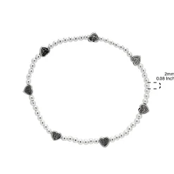 Zilveren armband met kraaltjes en bewerkte hartjes